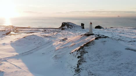 magical sunset at reykjanesviti lighthouse during winter season, aerial