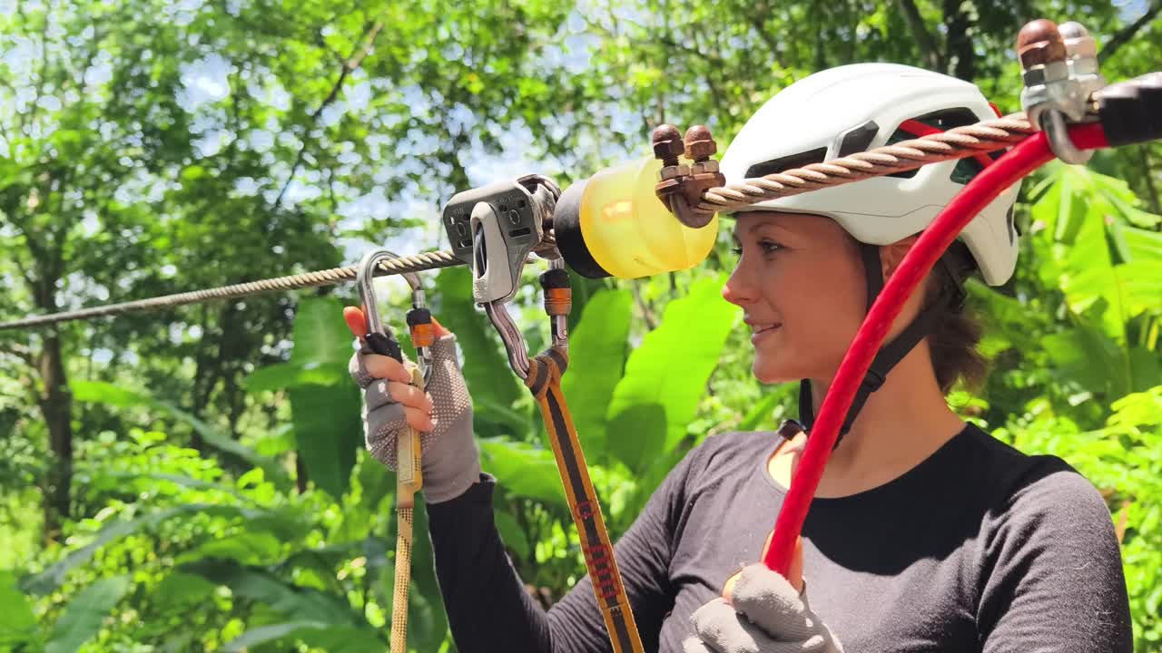 Woman ziplining through jungle canopy