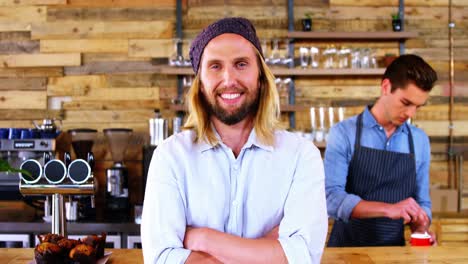 Smiling-costumer-standing-at-counter