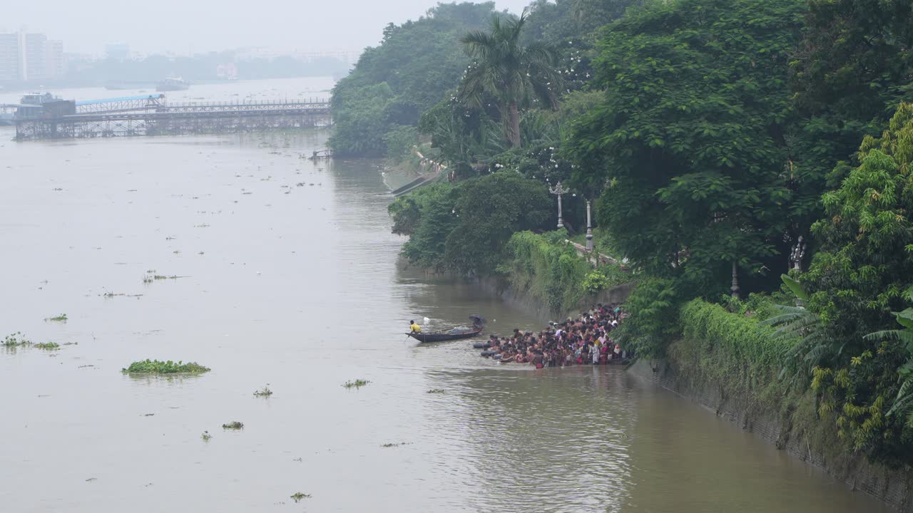 Large group of people bathing in a river
