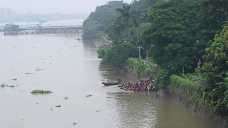 large group of people bathing in a river