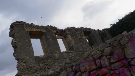 Low-angle-clip-of-birds-flying-over-the-ruined-remains-of-a-building-in-Mostar-Bosnia-and-Herzegovina