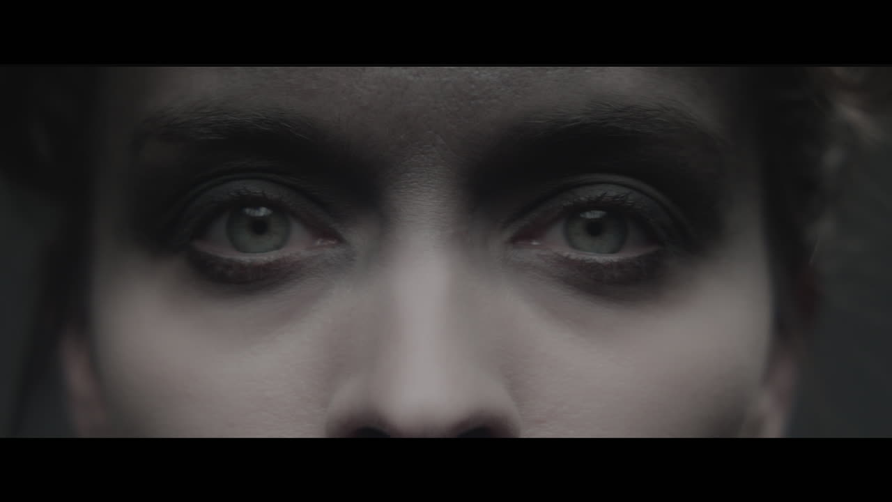 A woman dressed as mother opens her eyes