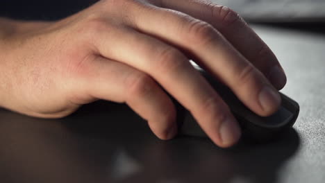 slow motion close up of a male hand using a wireless computer mouse