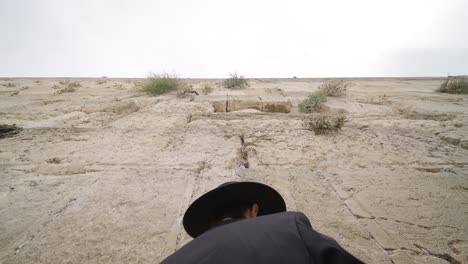 orthodox jewish male leyning in front of the western wall