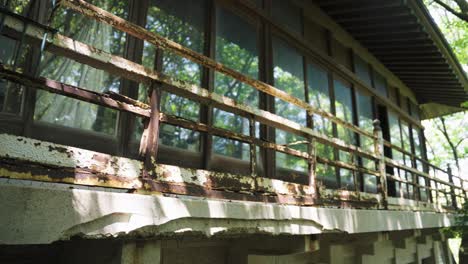 Decaying-Abandoned-Mansion-in-Japan,-Metal-Bars-Rusting-From-Neglect