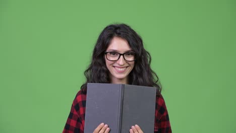 young beautiful businesswoman covering face with book