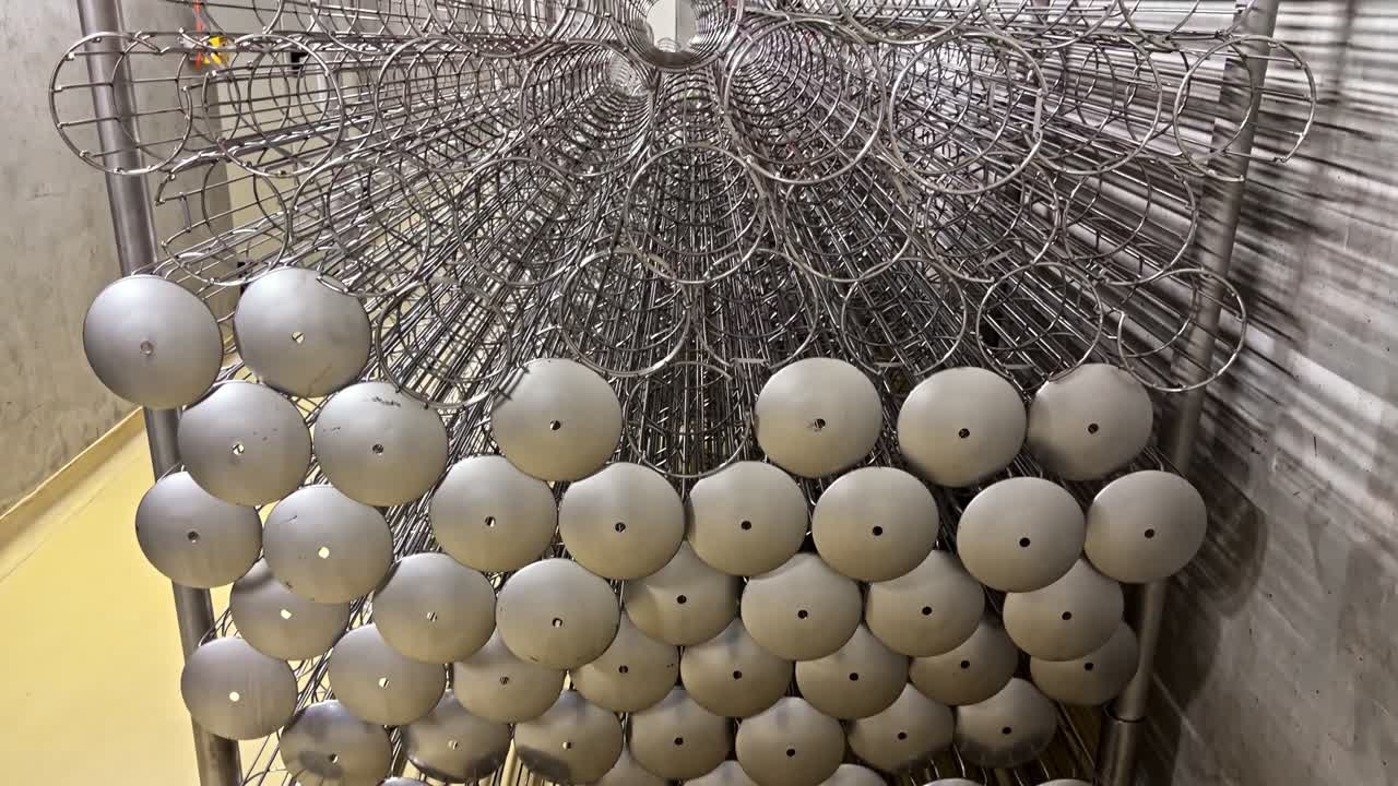 Stacked industrial filtration cylindrical items inside processing plant storage