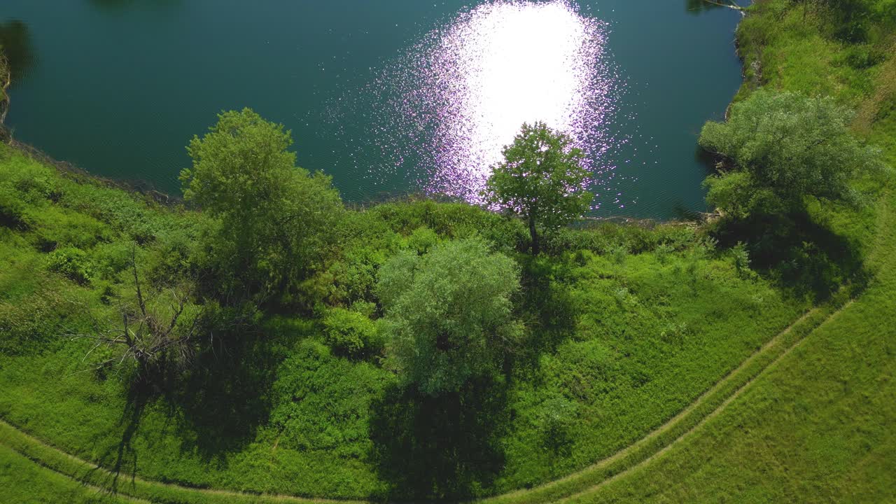 Top view aerial flight over small lake of perfectly round shape