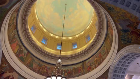 panning across from right to left looking up at hand panted murals on the utah state capital ceiling