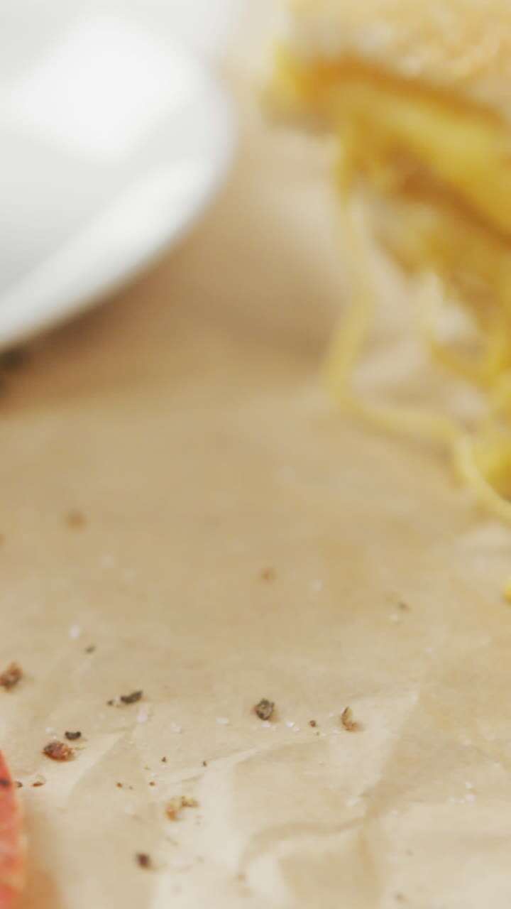 Video of slices of toasted cheese white bread sandwiches on paper and plate