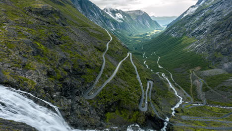 serpentine mountain road of trollstigen with stigfossen waterfall in norway