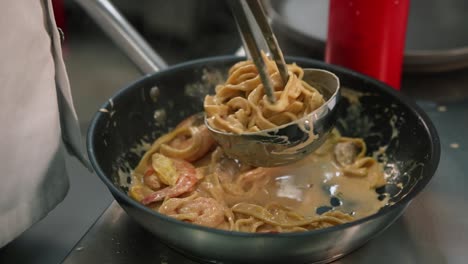 chef preparing creamy shrimp pasta