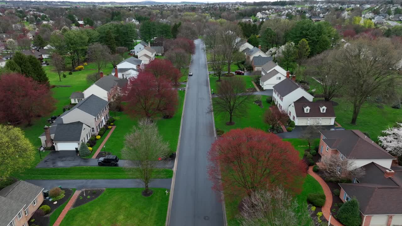 Aerial birds eye shot over homes and Buildings in american Suburb