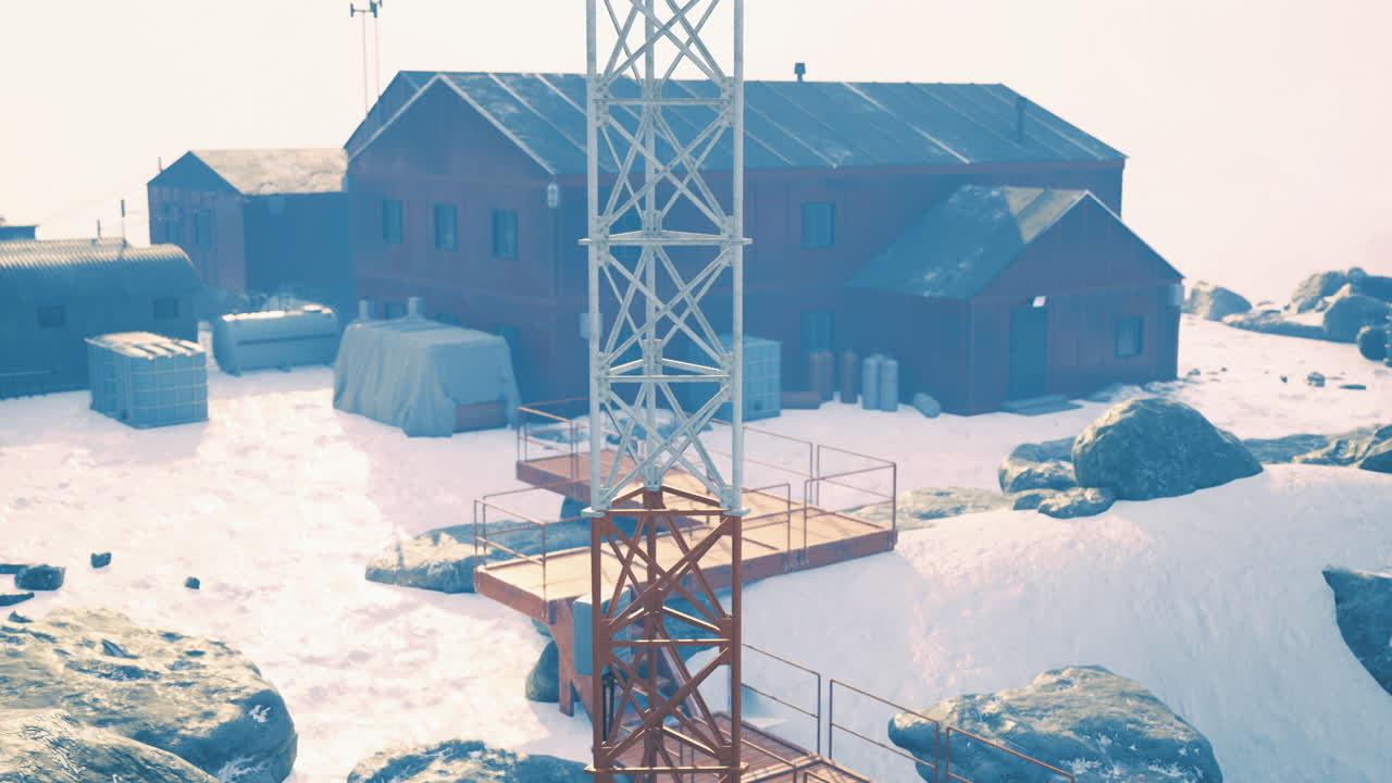 Snowy research facility with a communication tower and buildings
