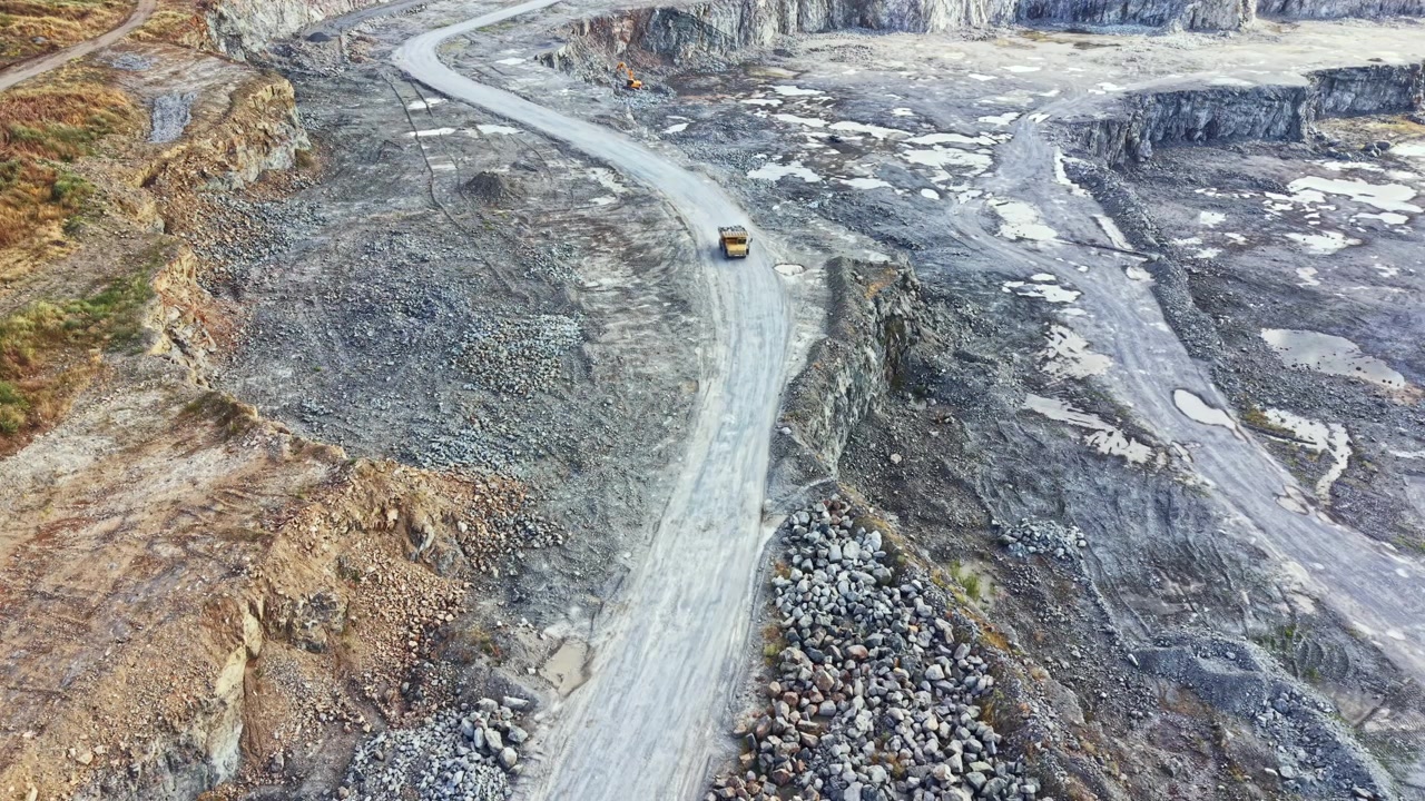 Granite quarry showing machinery and roads during daytime with rock formations and excavation areas in focus