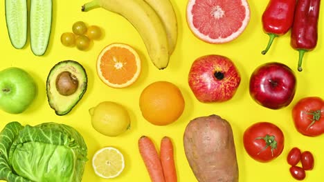 organic healthy fruits and vegetables in vivid colors make pattern on yellow background. stop motion flat lay