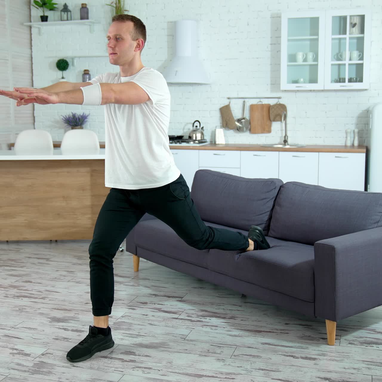 Sportsman doing morning fitness routine. Young man doing sports exercise at home