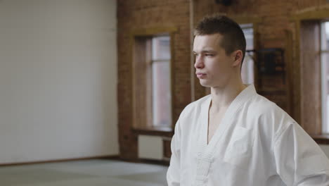 Young-man-with-white-uniform-indoors