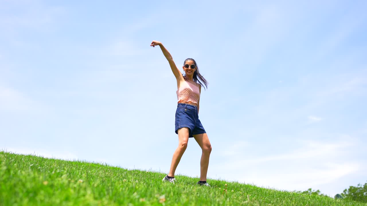 Woman having fun in a grassy field on a sunny day