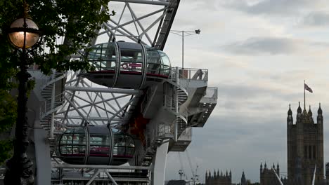 the london eye in the evening and palace of westminster, london, united kingdom