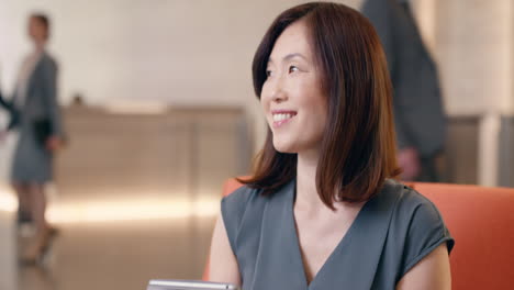 Japanese-Businesswoman-drinking-coffee-and-working-with-digital-tablet-technology