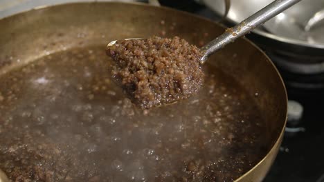 preparing the filling for saku sai moo thai traditional tapioca dumplings with pork filling, steaming hot filling