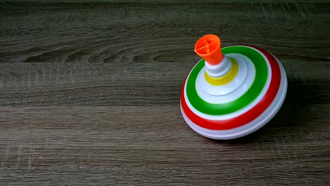 multicolored plastic spinning top or whirligig top is traditional toy for preschool child.