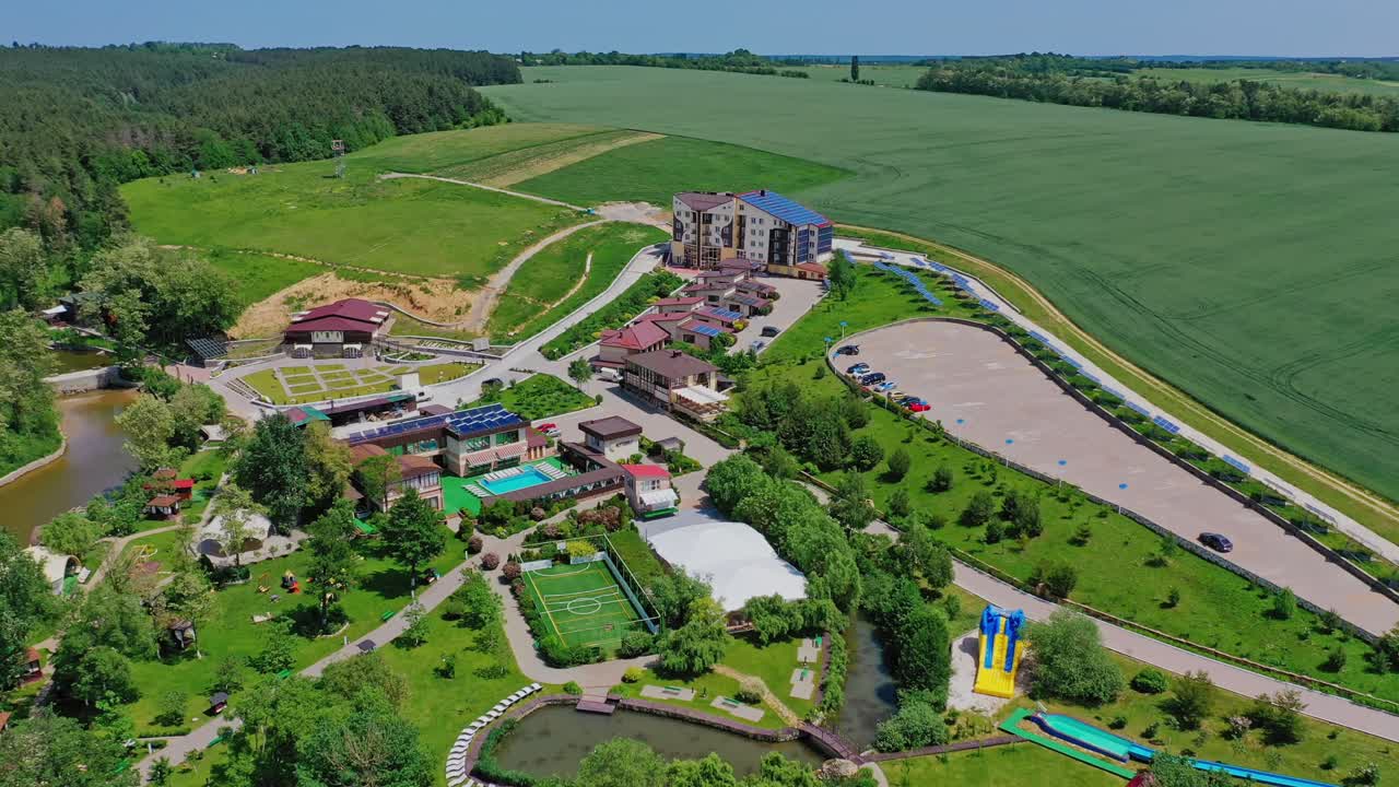 Modern complex for rest. Recreation area on beautiful nature background. Panoramic view of outdoor park to relax for summer vacation. Aerial view.