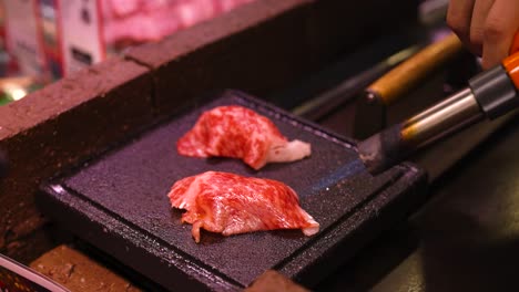 steak being seared on a hot griddle