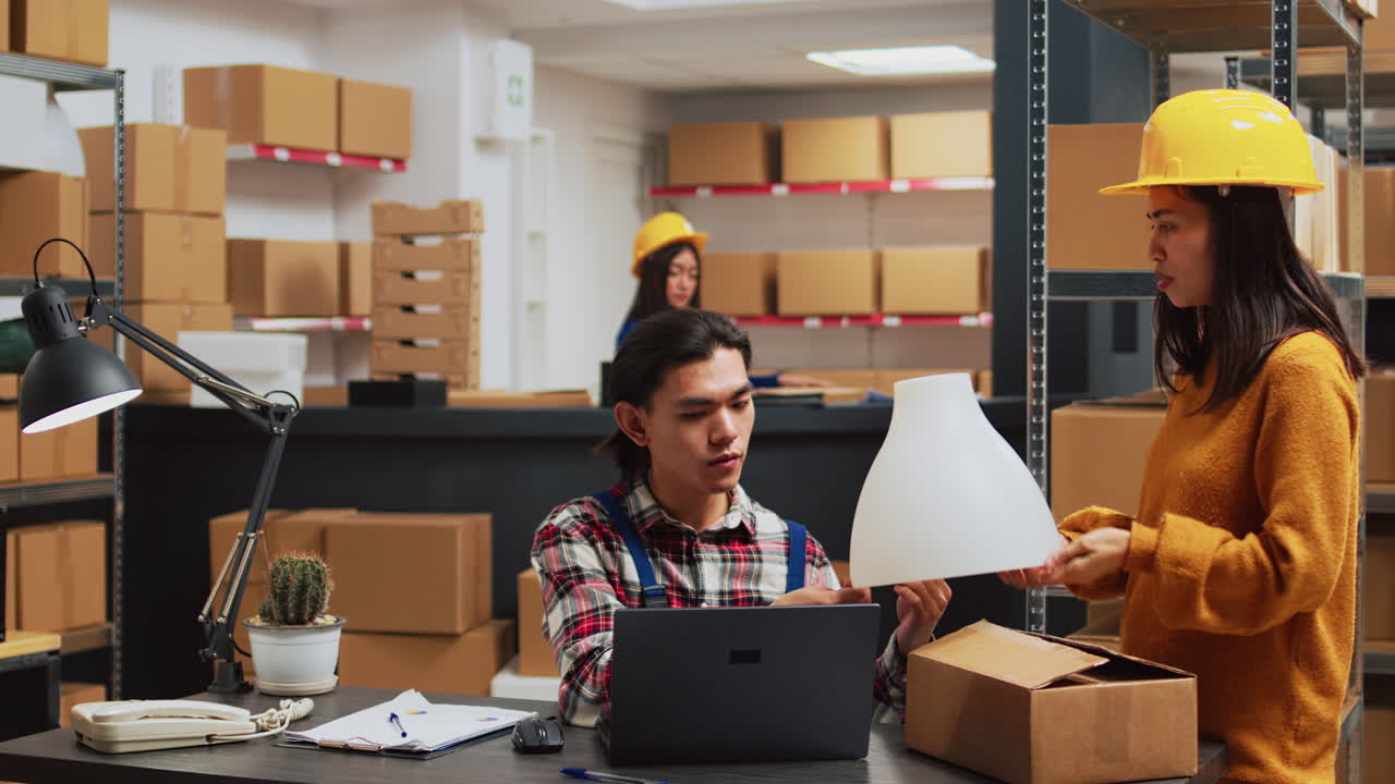 Warehouse workers with boxes and laptops