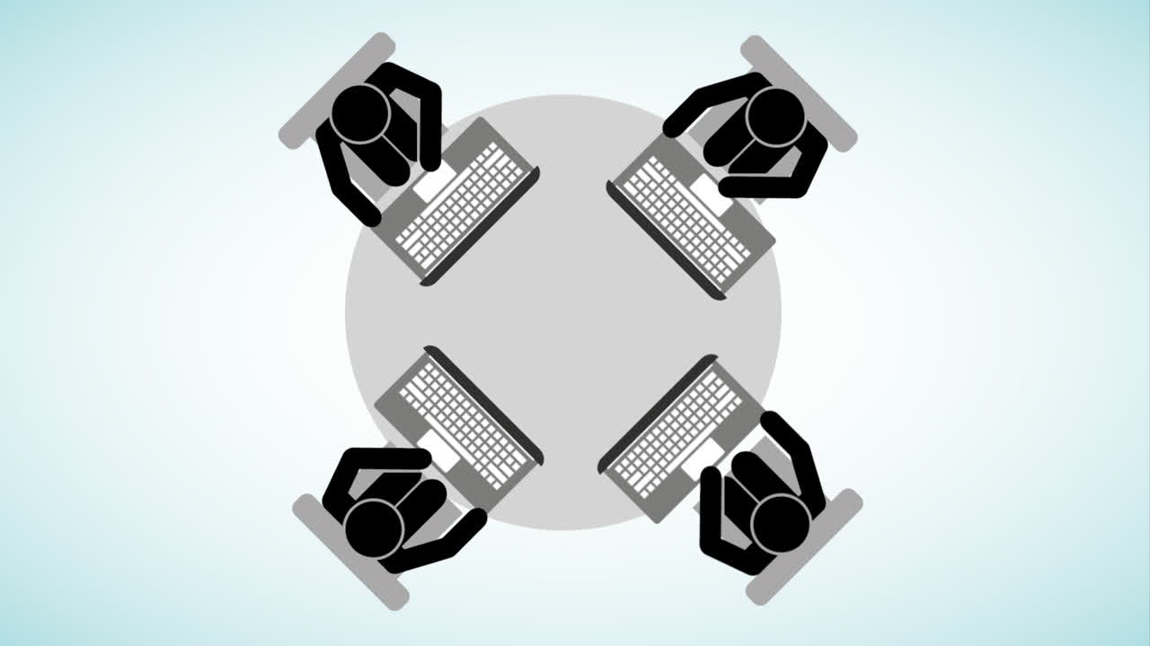 People in a Meeting Around a Table with Laptops