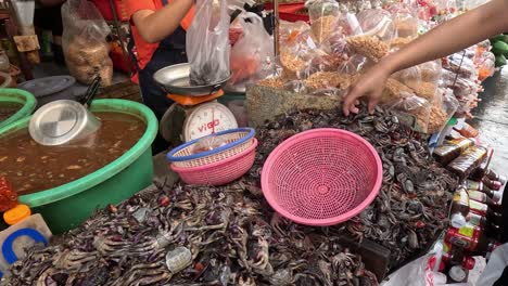 vendor selling seafood at a busy market