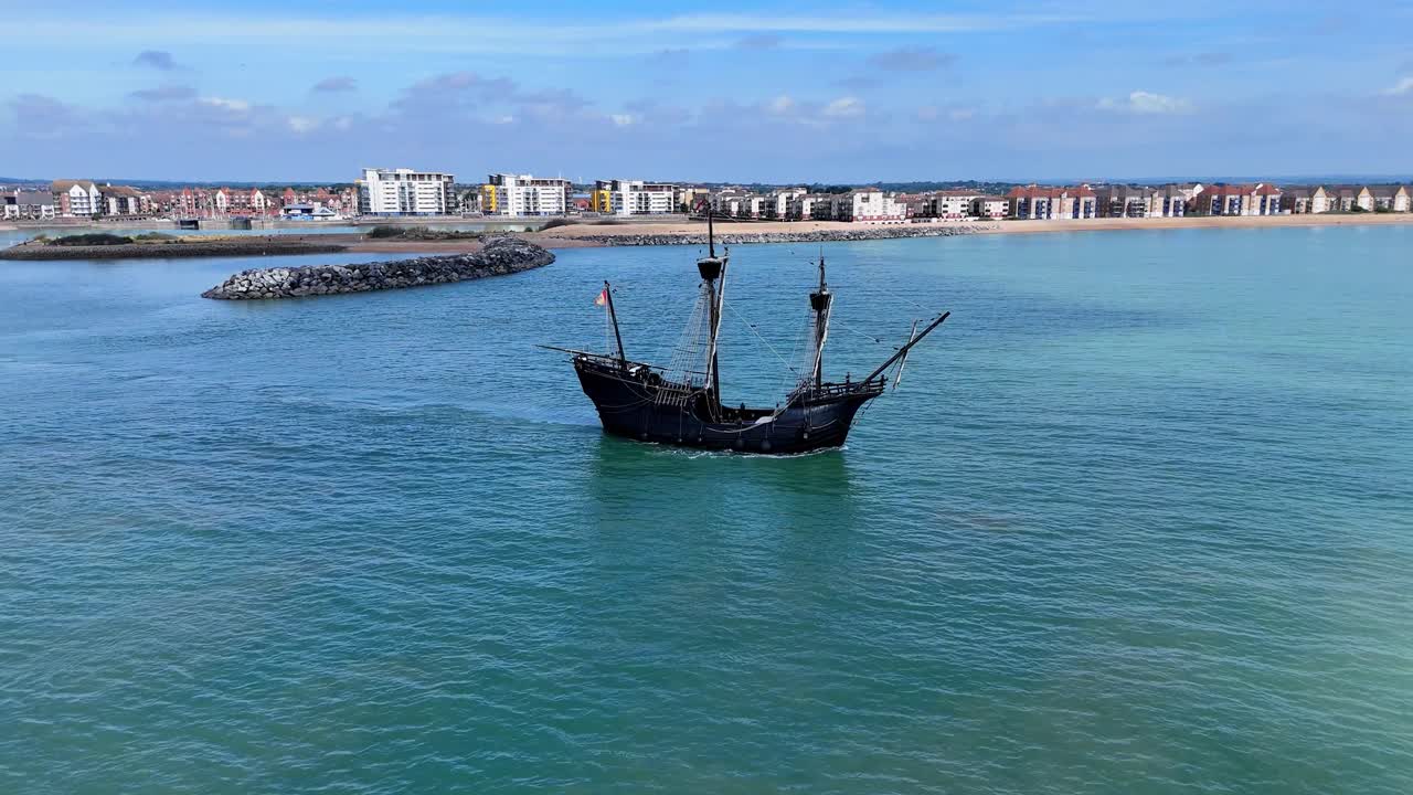 Stunning drone view of the Nao Victoria replica ship leaving harbour, capturing the elegance of maritime heritage in motion.