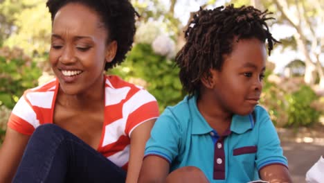 portrait of cute family is sitting in a park