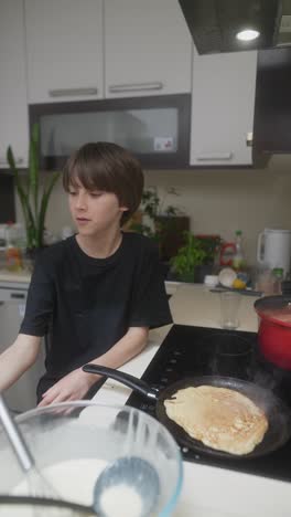 boy cooking pancakes