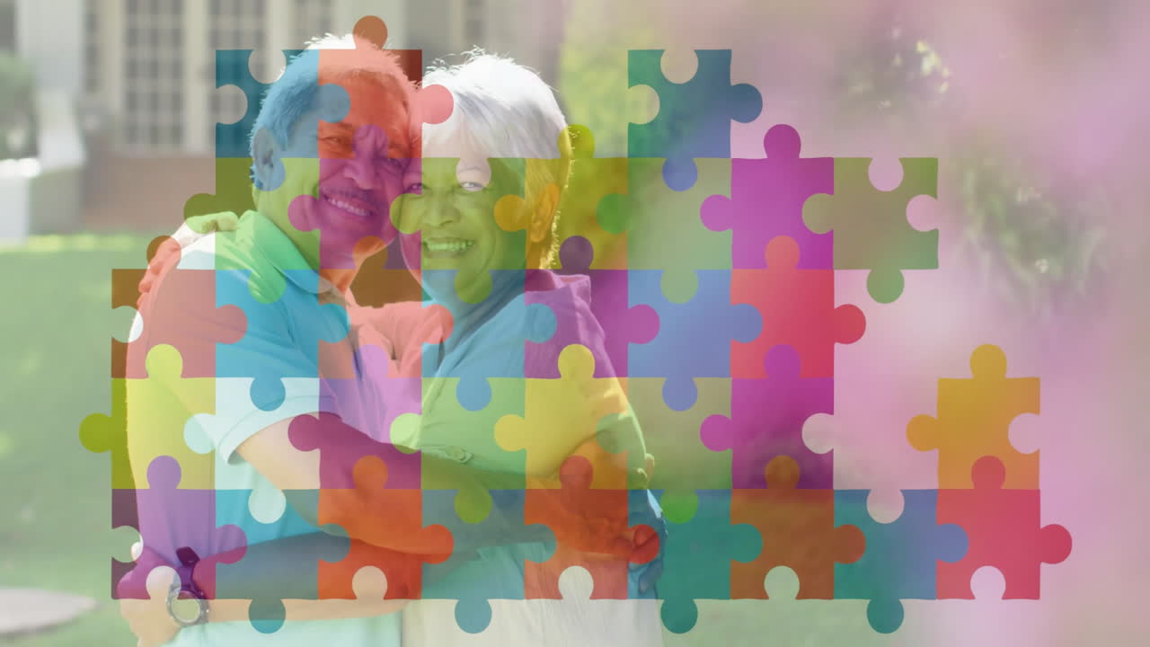 Smiling elderly couple embracing with colorful puzzle piece animation overlay