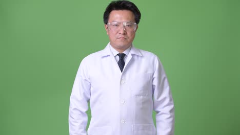 mature japanese man doctor wearing protective glasses