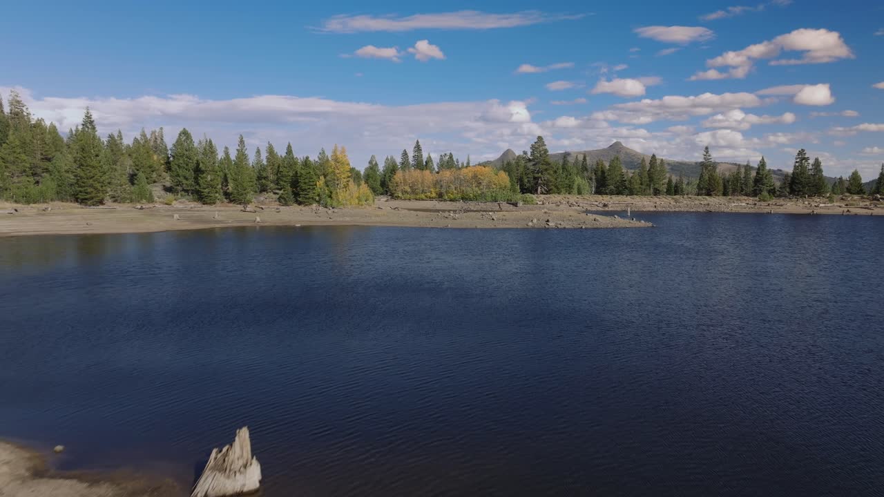 Tranquil lake with trees and a boat at Scotts Lake, serene outdoor scene