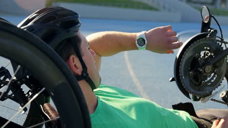 disabled athlete using smartwatch on a running track 4k