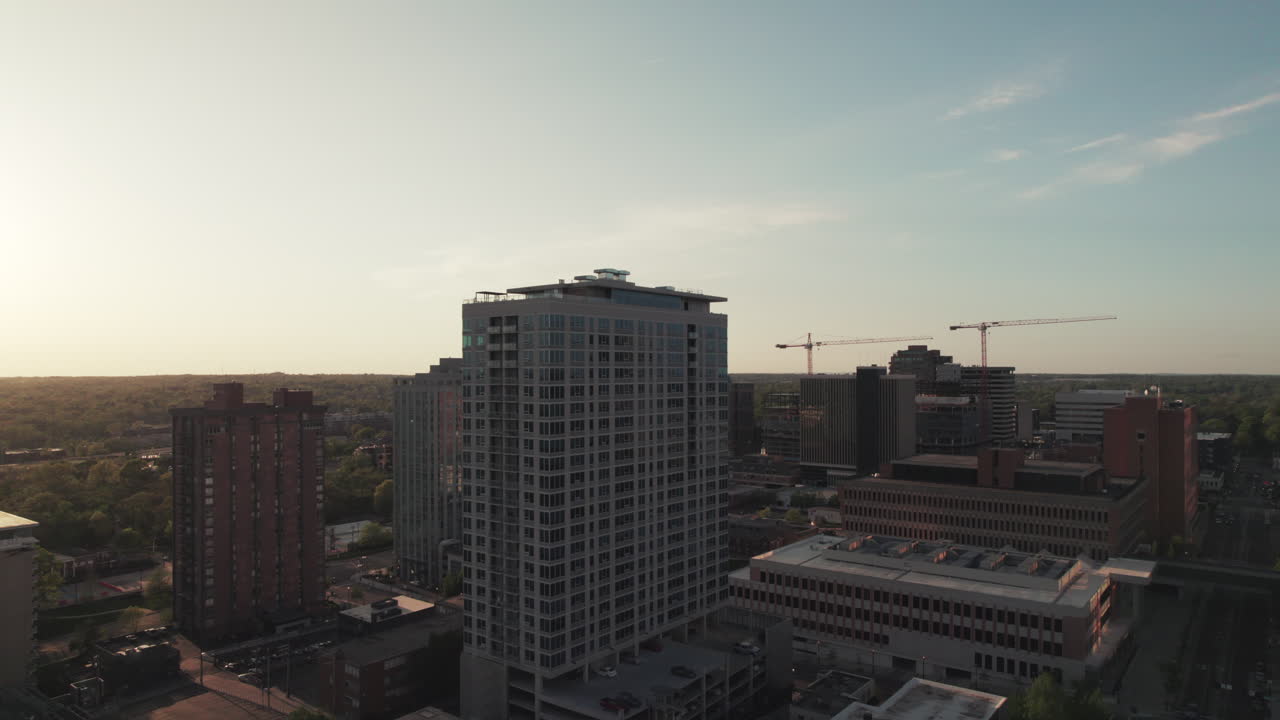 Rising aerial parallax around high rise office building at sunset, Clayton, Missouri.