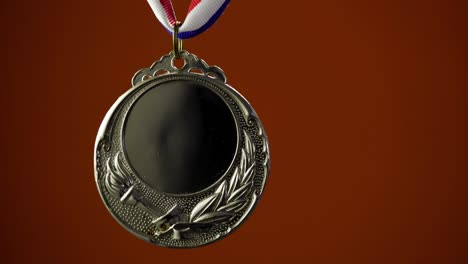 gold medal on orange background