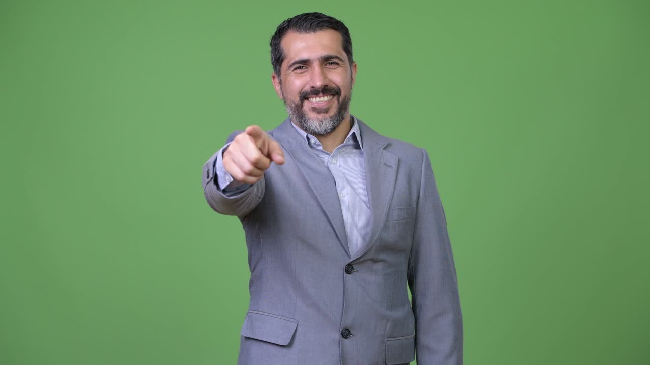 Handsome Persian bearded businessman pointing to camera