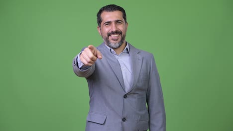 handsome persian bearded businessman pointing to camera