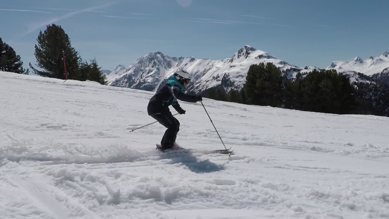 Professional skier is showing awesome ski turns on point. Super steady filming with the best mountain view in the alps. Sixty pitucers