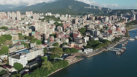 tamsui district, taipei, with urban landscape, green hills, and waterfront, on a sunny day, aerial view