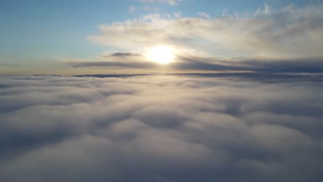 dronebeelden uitzoomen boven de wolken bij zonsondergang