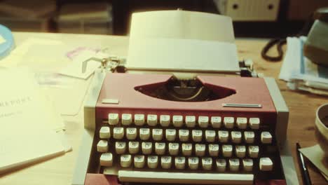 Typewriter, Coffee Cup and Criminal Investigation Documents on Desk