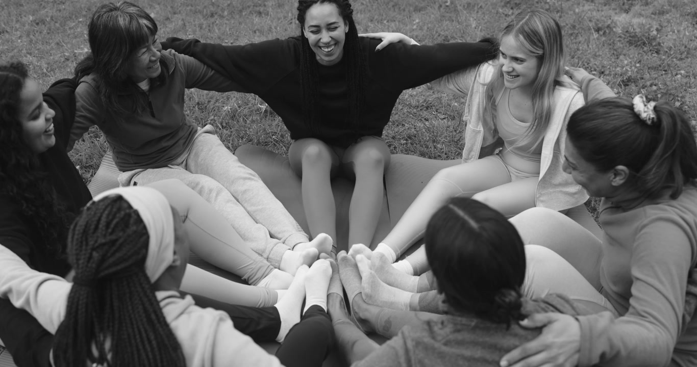 Diverse Group of Women Sitting in a Circle on Grass