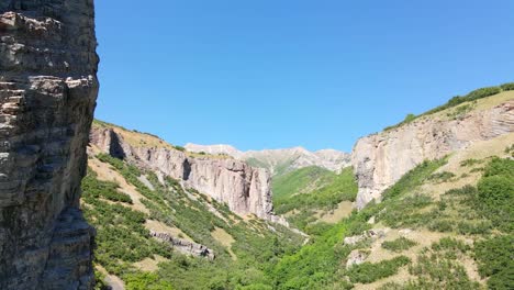 flying backward and dangerously close to as shear cliff in a rugged canyon wilderness